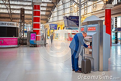 Unidentified people travel through trains at Liverpool Lime Street station Editorial Stock Photo