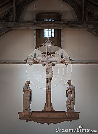 The Rood, hanging above the altar. Jesus hanging on the cross and The Virgin Mary and St.John (The evangelist) statues Stock Photo