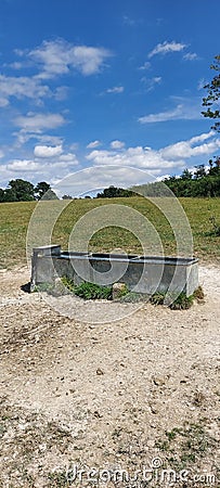 Livestock water trough in field. Stock Photo