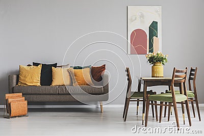 Living and dining room interior with sofa and wooden table with vintage chairs Stock Photo