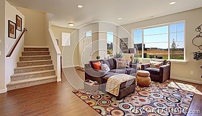Living room with brown couch and cheerful rug Stock Photo