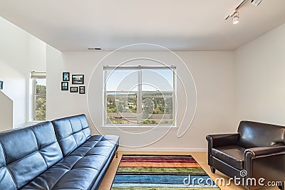 Living room with colorful carpet window overlooking forest city and water view Editorial Stock Photo