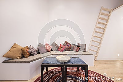 Living room decorated in Moroccan style with a long-cushioned sofa Stock Photo