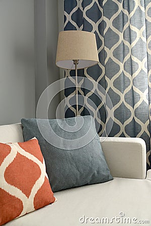 Living room interior fragment with a floor lamp and throw pillows Stock Photo