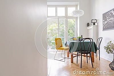 Living room interior with table cloth and different kind of chairs, black map on the wall, real photo with Stock Photo