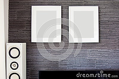 Living room wall with two empty frames and loudspeaker Stock Photo