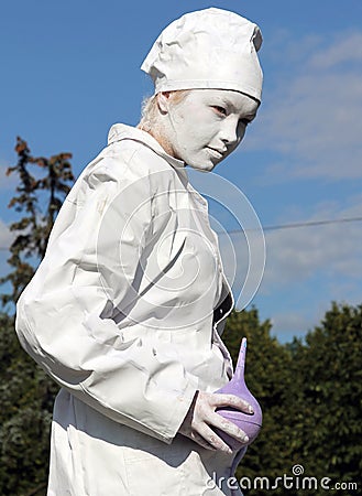 Living statue of a doctor with enema in her hands Editorial Stock Photo