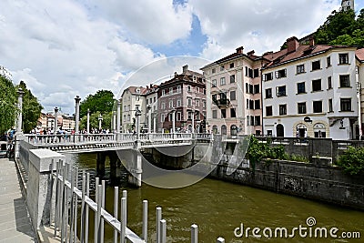 The Ljubljanica River in Ljubljana, Slovenia, With Busy Summer Crowds on the Riverwalk Editorial Stock Photo