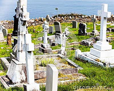 LLandudno, Wales, North Shore Beach, UK - MAY 27, 2018 Tombstones in cemetery at sunny Some headstones old abandoned churchyard. G Editorial Stock Photo