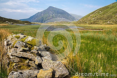 Llyn Idwal is a small lake that lies within Cwm Idwal in the Glyderau mountains of Snowdonia. Stock Photo