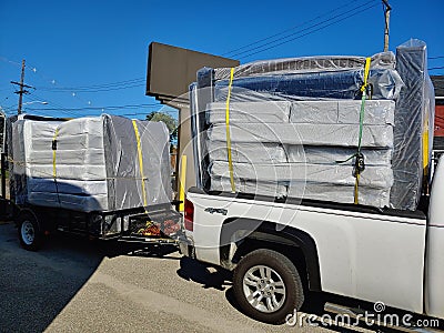 Load of mattresses on a truck and trailer Editorial Stock Photo