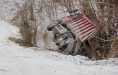 Loaded truck overturned on a slippery winter road Stock Photo