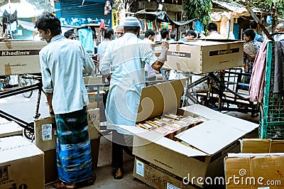 Loader unloading or unpacking cardboard container or shipment box cartoon. Logistics concept Editorial Stock Photo