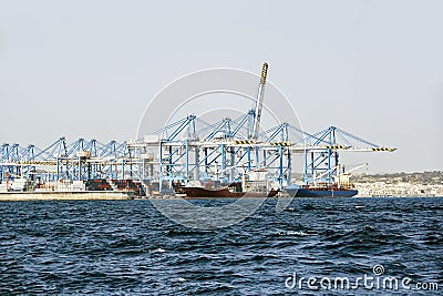 Loading of bulk carriers against background of a large number of bridge cranes Stock Photo