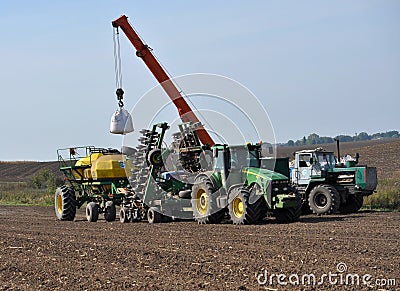 Loading bunker seeders from big bags Editorial Stock Photo