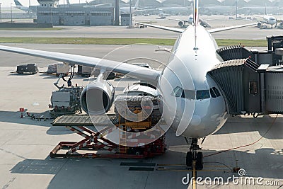 Loading cargo on plane in airport before flight. Foreman control Editorial Stock Photo