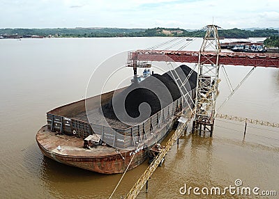 Loading coal onto the barge from the stock pile, aerial view Editorial Stock Photo