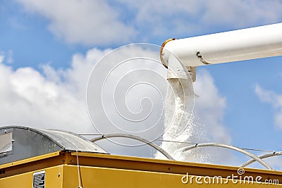 Loading fertilizer into a spreader. Stock Photo