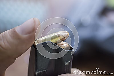 Loading Handgun Magazine. Bullets and Pistol Background. Charging Gun. Stock Photo