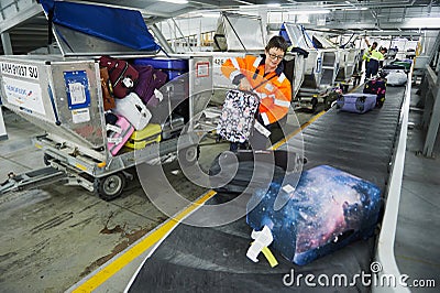 Loading and unloading operations and baggage control at the airport. Service for the transportation of belongings of aircraft Editorial Stock Photo