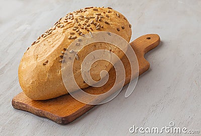 A loaf of rye bread sunflower seeds on a cutting board Stock Photo