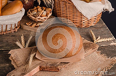 Loaf of traditional round rye bread on wooden background Stock Photo