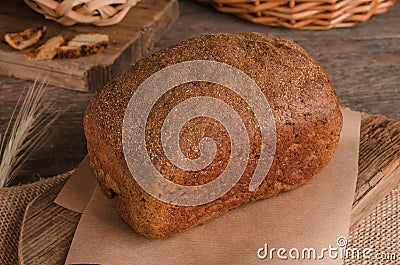 Loaf of traditional rye bread on wooden background Stock Photo