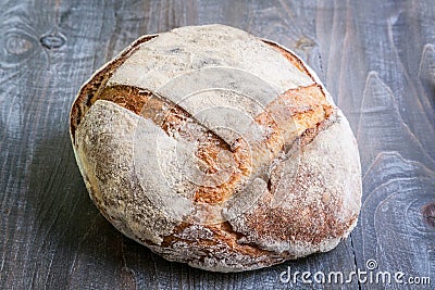 Loafs or miche of French sourdough, called as well as Pain de campagne, on display on a wooden table. Stock Photo