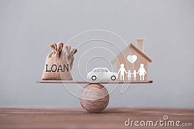 Loan bags with family member and car in a house on balance scale. Concept family financial management, mortgage and payday loan or Stock Photo