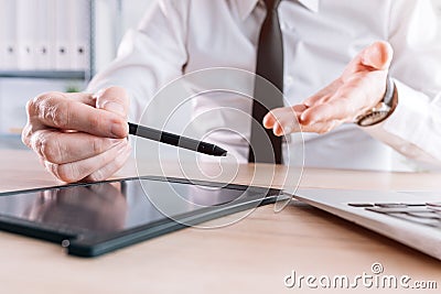 Loan officer and banker offering stylus and pad to sign document with electronic signature Stock Photo
