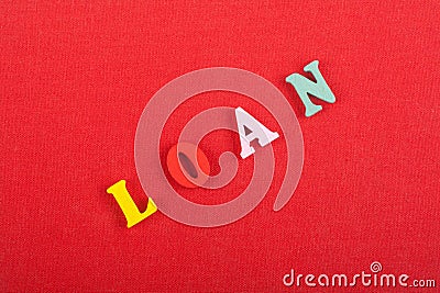 LOAN word on red background composed from colorful abc alphabet block wooden letters, copy space for ad text. Learning english Stock Photo