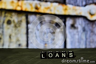 Loans on wooden blocks. Cross processed image with bokeh background Stock Photo