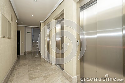 Lobby of a building with three elevators Stock Photo