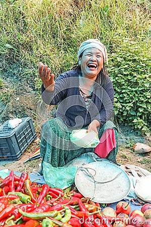 Lobesa Village, Punakha, Bhutan - September 11, 2016: Unidentified smiling woman at weekly farmers market. Editorial Stock Photo