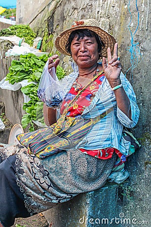 Lobesa Village, Punakha, Bhutan - September 11, 2016: Unidentified smiling woman at weekly farmers market. Editorial Stock Photo