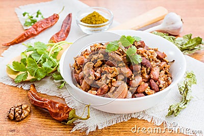 Lobio - the national Georgian dish of beans in a white plate and the ingredients for its preparation Stock Photo