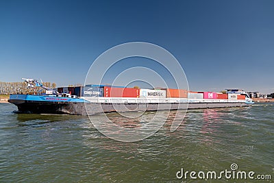 Lobith Netherlands, April 2020, large container vessel on the river rhein near germany with colorful containers on board Editorial Stock Photo