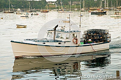 Lobster boat leaving harbor Stock Photo