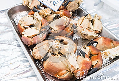 Lobster claws on a silver tray with euro sign in Paris market Stock Photo