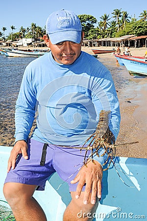 Lobster fisherman on the beach of Los Cobanos Editorial Stock Photo