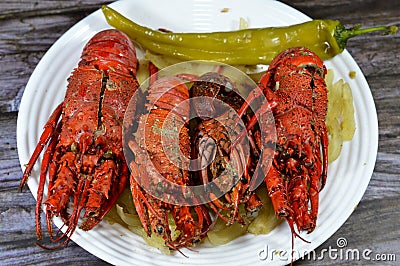 Lobster meal cooked and served, Lobsters are a family Nephropidae, Homaridae of marine crustaceans, with long bodies and muscular Stock Photo