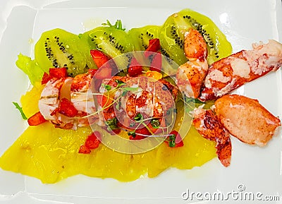 lobster salad with lobster and a bed of strawberries kiwis and pieces of pineapple Stock Photo