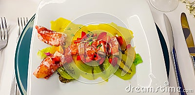 lobster salad with lobster and a bed of strawberries kiwis and pieces of pineapple Stock Photo