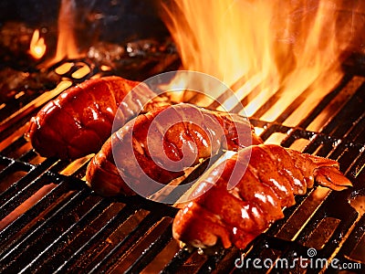 Lobster tails cooking on grill Stock Photo