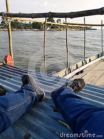 Local Asian fishermen boat in the river of Meghna. Fishing boat at the river in the morning. Stock Photo