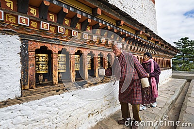 Local Bhutanese turning prayer wheels Editorial Stock Photo