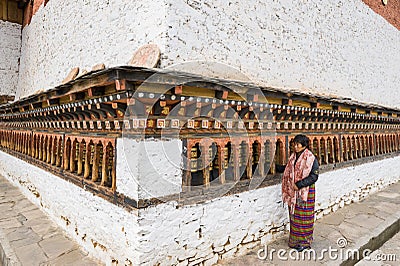 Local Bhutanese turning prayer wheels Editorial Stock Photo