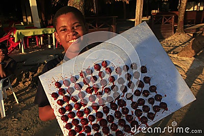 Local boy selling sweets at Boca Chica beach Editorial Stock Photo