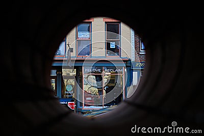 Local business and cafe view through pipeline in Troy NY. Editorial Stock Photo