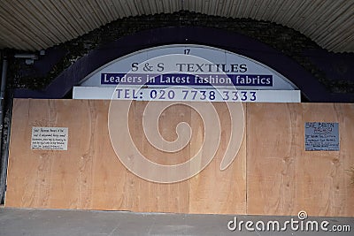 Boarded up shop under the Arches in Brixton,UK. Editorial Stock Photo